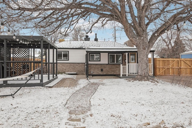 view of snow covered rear of property