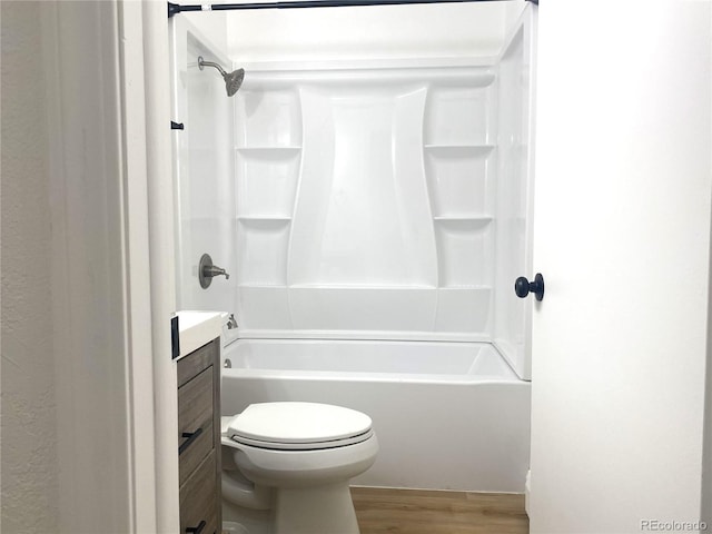 bathroom with toilet, vanity, shower / bathing tub combination, and wood finished floors