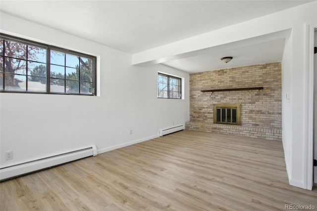 unfurnished living room with a fireplace, a baseboard radiator, and wood finished floors