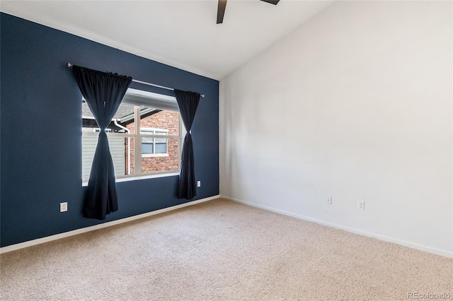 carpeted empty room featuring lofted ceiling and ceiling fan