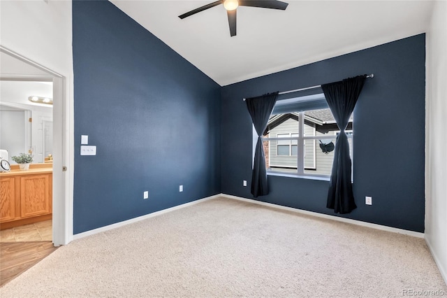 unfurnished room featuring vaulted ceiling, ceiling fan, and carpet flooring