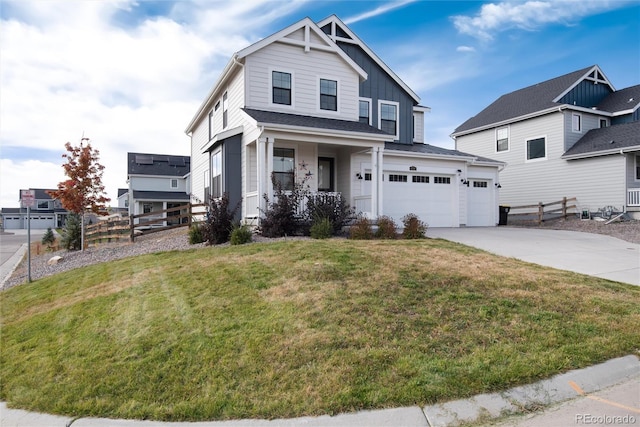 view of front facade with covered porch, a front yard, and a garage