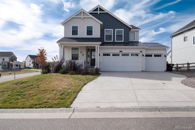 view of front of property with a porch, a garage, and a front lawn