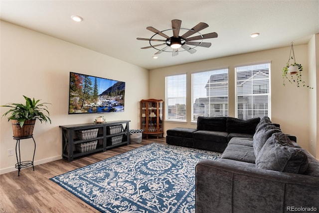 living room featuring hardwood / wood-style flooring and ceiling fan