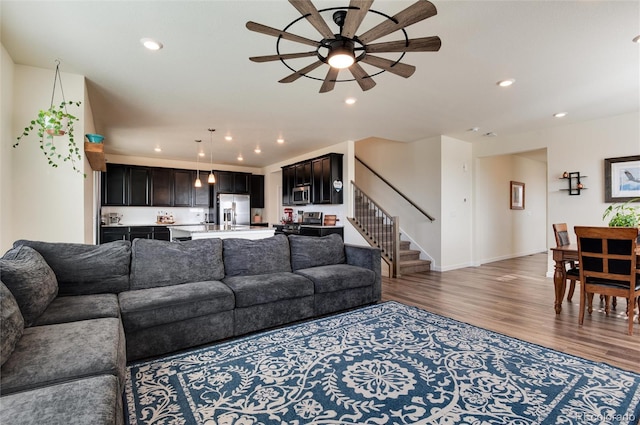 living room with ceiling fan and hardwood / wood-style floors