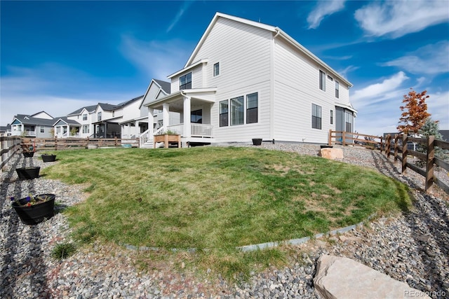 exterior space featuring covered porch and a lawn