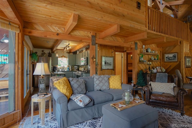 living room featuring light hardwood / wood-style flooring, wood walls, beam ceiling, and wooden ceiling