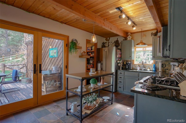 kitchen with hanging light fixtures, wood ceiling, decorative backsplash, high quality fridge, and french doors