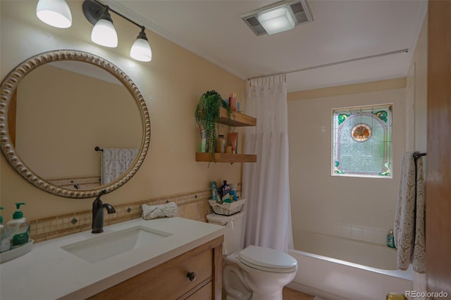 full bathroom featuring shower / bath combo, vanity, and toilet