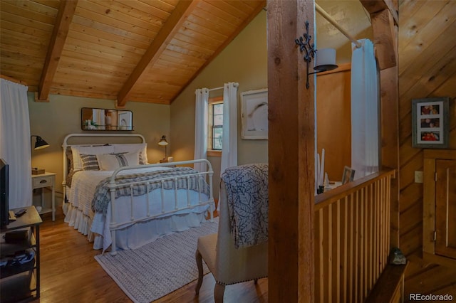 bedroom featuring light wood-type flooring, vaulted ceiling with beams, and wood ceiling