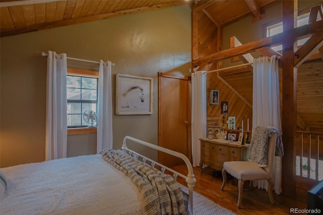 bedroom with lofted ceiling with beams, wooden ceiling, wood walls, and hardwood / wood-style flooring