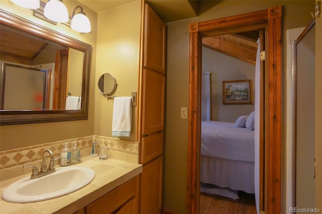 bathroom with decorative backsplash, vanity, hardwood / wood-style floors, and an enclosed shower