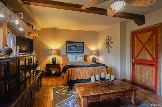 bedroom with hardwood / wood-style flooring and beam ceiling