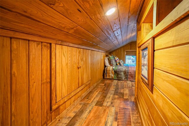 corridor featuring wooden ceiling, wooden walls, vaulted ceiling, and hardwood / wood-style flooring