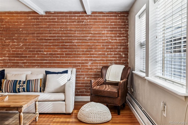 160 Jackson St Unit 5, Denver, CO 80206 - sitting room with healthy amount of natural light, wood finished floors, beam ceiling, brick wall, and a baseboard radiator