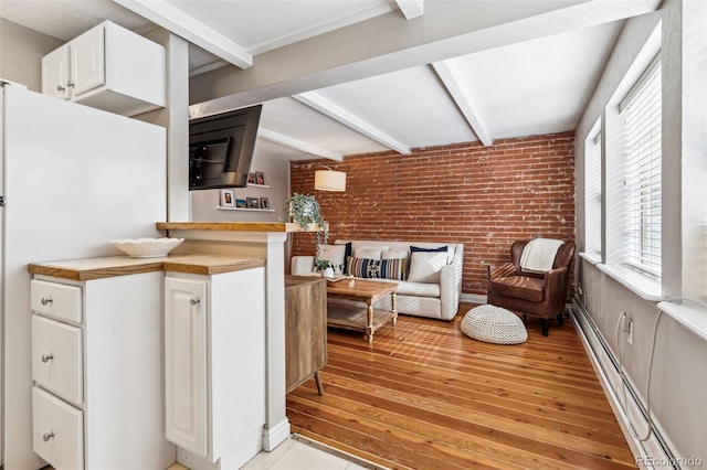 160 Jackson St Unit 5, Denver, CO 80206 - living area with beam ceiling, brick wall, baseboard heating, and light wood finished floors