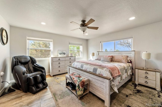 1882 N Rough Rock Ln, Pueblo West, CO 81007 - bedroom with light wood-type flooring, a textured ceiling, recessed lighting, and ceiling fan