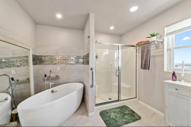 1882 N Rough Rock Ln, Pueblo West, CO 81007 - full bath featuring a stall shower, a freestanding bath, recessed lighting, baseboards, and vanity