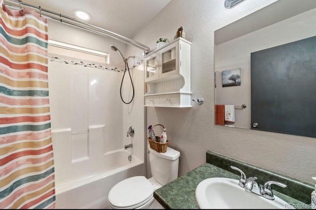 1882 N Rough Rock Ln, Pueblo West, CO 81007 - bathroom featuring toilet, shower / bath combo with shower curtain, vanity, and a textured wall