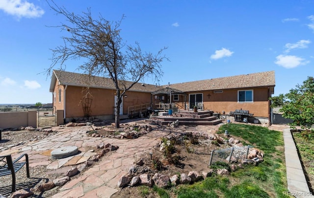 1882 N Rough Rock Ln, Pueblo West, CO 81007 - rear view of house with a patio, fence, and stucco siding