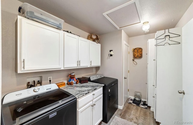 1882 N Rough Rock Ln, Pueblo West, CO 81007 - laundry room featuring washing machine and dryer, light wood-type flooring, cabinet space, baseboards, and attic access