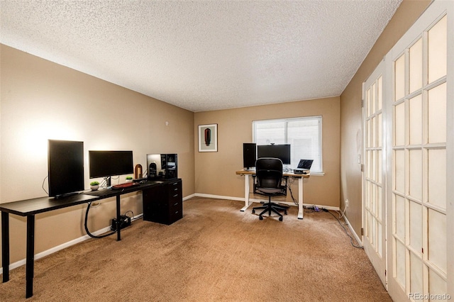 carpeted office featuring a textured ceiling and baseboards