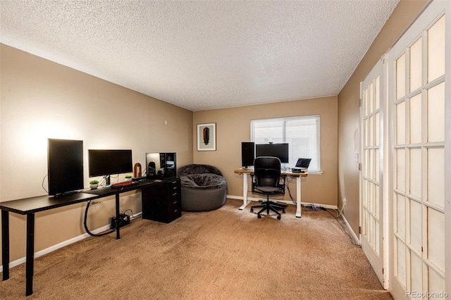 office space with a textured ceiling, baseboards, and carpet floors