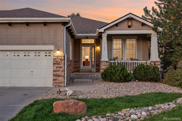 view of front of property featuring a porch and a garage