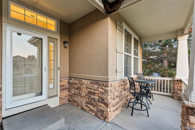 view of exterior entry with covered porch