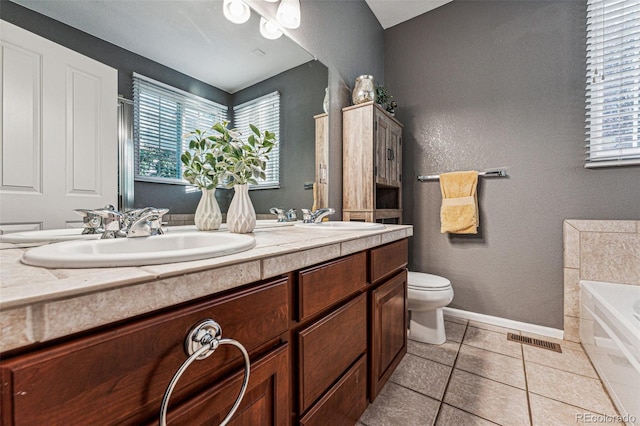 bathroom featuring a bath, plenty of natural light, vanity, and toilet