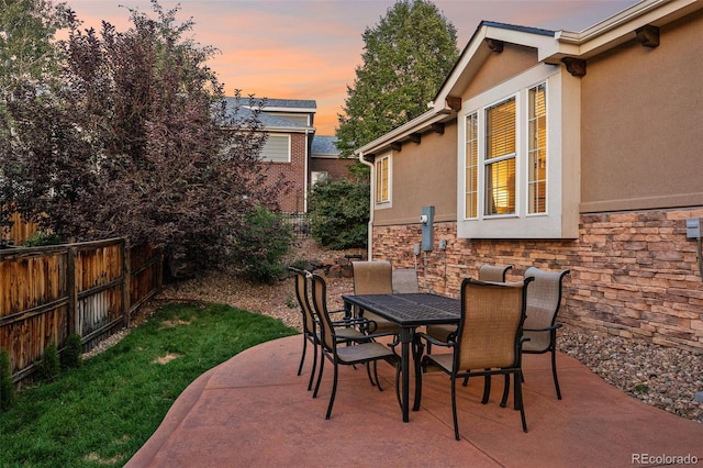 view of patio terrace at dusk