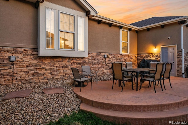 view of patio terrace at dusk