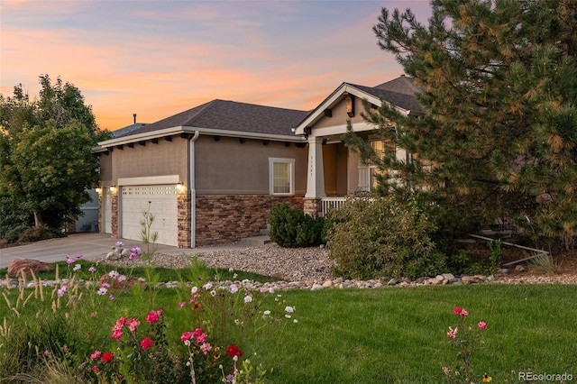 view of front of property featuring a lawn and a garage