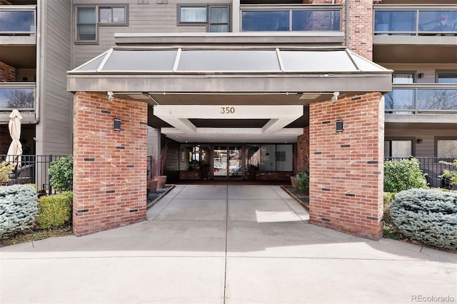 350 Detroit St Unit 107, Denver, CO 80206 - doorway to property featuring brick siding and driveway