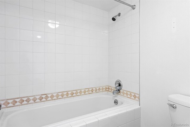 350 Detroit St Unit 107, Denver, CO 80206 - bathroom featuring toilet, a shower, and tiled bath