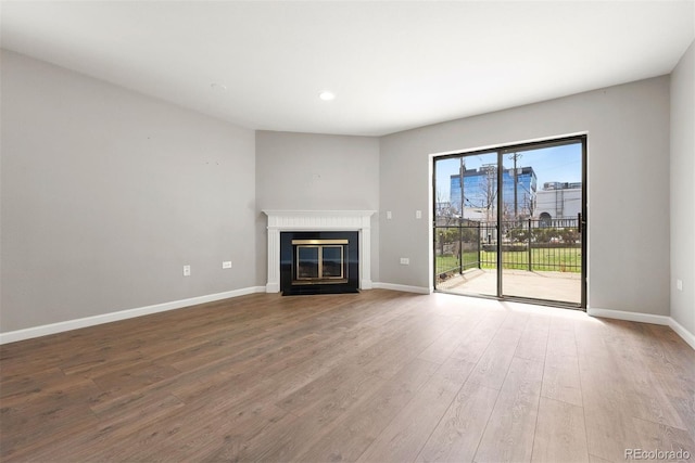 350 Detroit St Unit 107, Denver, CO 80206 - unfurnished living room with recessed lighting, baseboards, a fireplace with flush hearth, and wood finished floors