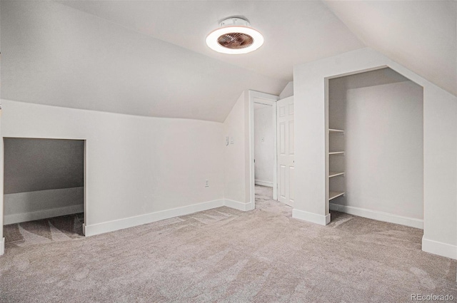 bonus room with carpet flooring, lofted ceiling, and baseboards