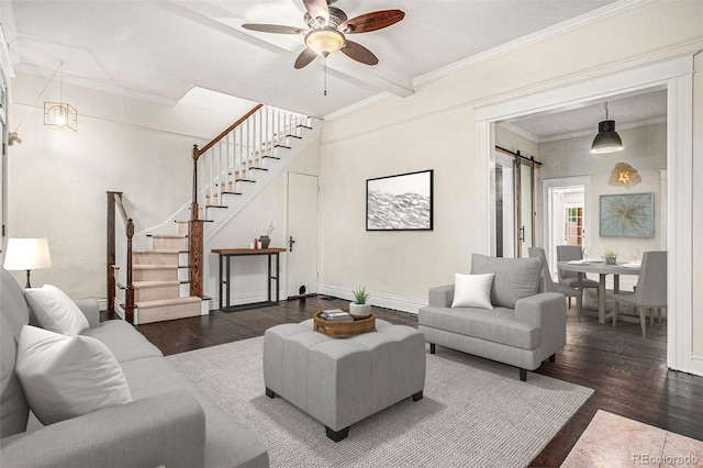 living area featuring wood finished floors, stairway, a ceiling fan, crown molding, and a barn door