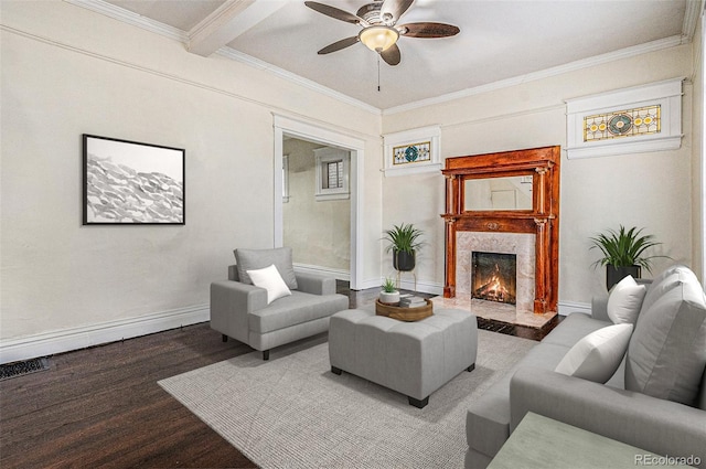 living area featuring a ceiling fan, wood finished floors, a premium fireplace, ornamental molding, and baseboards