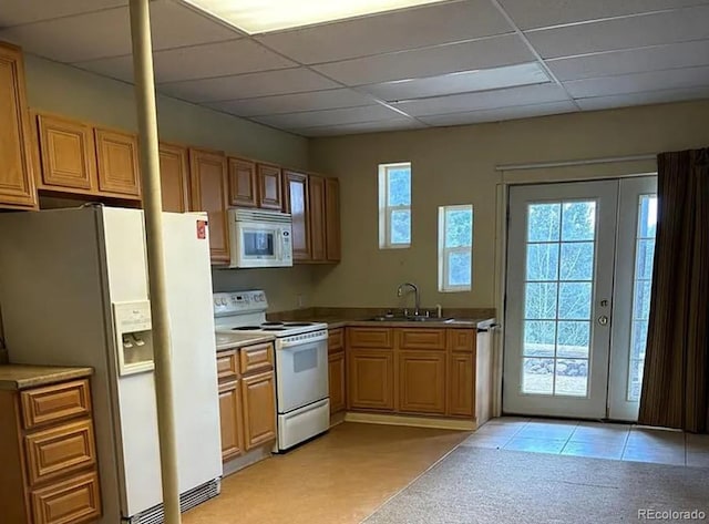 3647 Pathfinder Rd Unit B, Florissant, CO 80816 - kitchen with white appliances, a drop ceiling, light carpet, and french doors