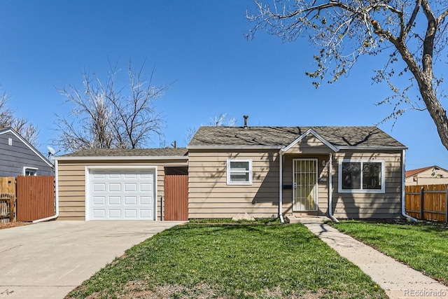 view of front facade with fence, an attached garage, concrete driveway, and a front lawn