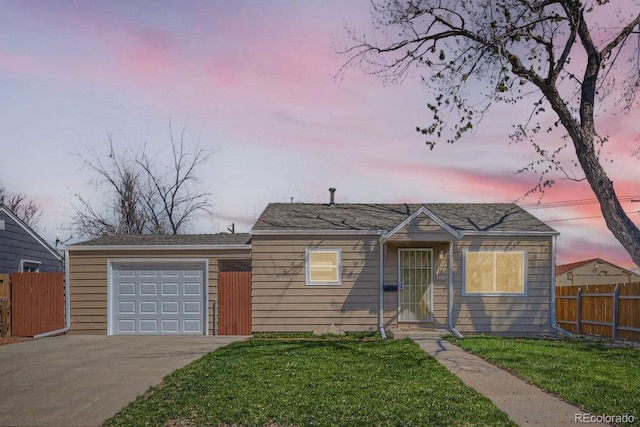 view of front facade featuring fence, a yard, and concrete driveway