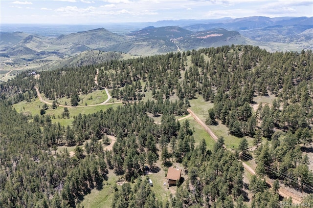 3600 Blue Mountain Trl, Lyons, CO 80540 - aerial view of property and surrounding area featuring mountains and a heavily wooded area