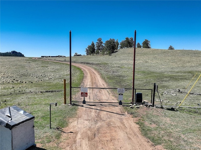 777 Deerview Dr, Florissant, CO 80816 - view of road featuring a gate and a rural view