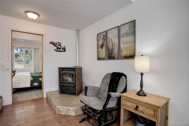 777 Deerview Dr, Florissant, CO 80816 - sitting room featuring a wood stove and wood finished floors