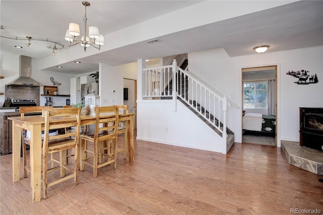 777 Deerview Dr, Florissant, CO 80816 - dining space with a chandelier, stairway, light wood finished floors, and baseboards