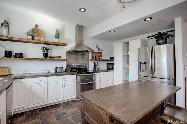 777 Deerview Dr, Florissant, CO 80816 - kitchen with open shelves, island range hood, stainless steel appliances, dark countertops, and white cabinets