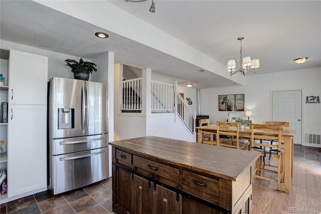 777 Deerview Dr, Florissant, CO 80816 - kitchen with stainless steel refrigerator with ice dispenser, a chandelier, dark brown cabinetry, and hanging light fixtures