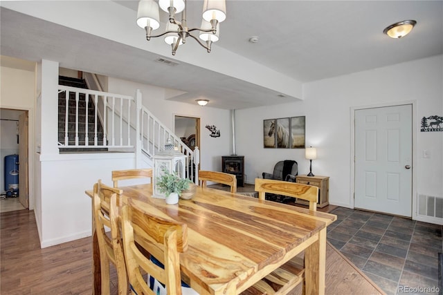 777 Deerview Dr, Florissant, CO 80816 - dining space with stairway, a chandelier, a wood stove, and baseboards
