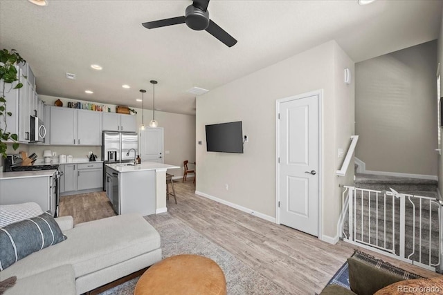 19592 W 93rd Pl Unit C, Arvada, CO 80007 - living area with light wood-type flooring, a ceiling fan, recessed lighting, and stairway